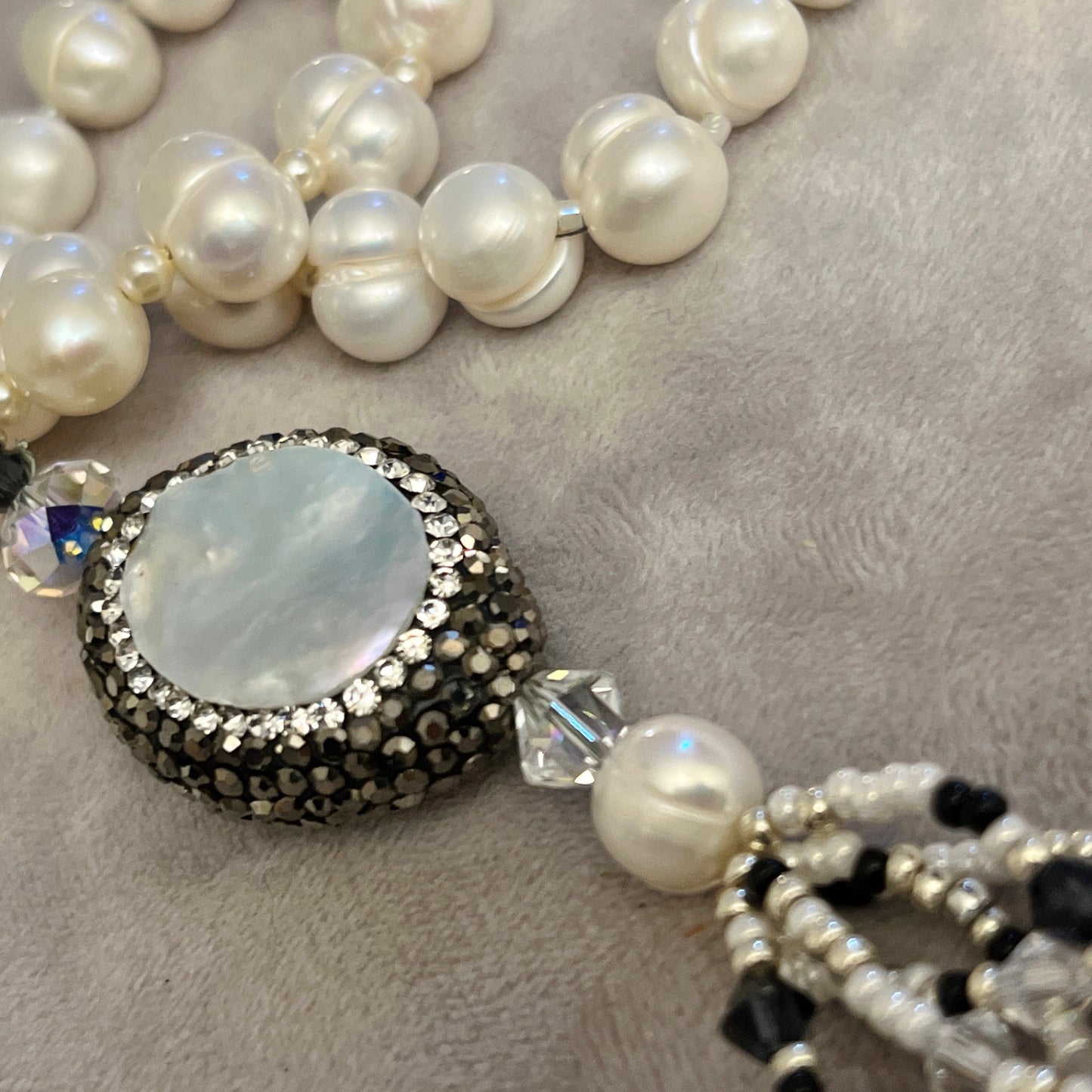 Pearl  with elements in  Mother of Pearl surrounded by crystals